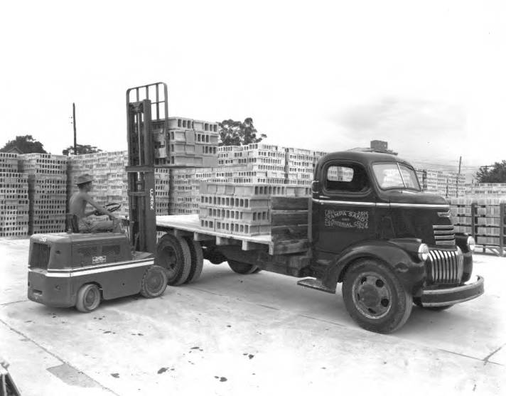 Forklift loading a Tampa Sand and Materials truck